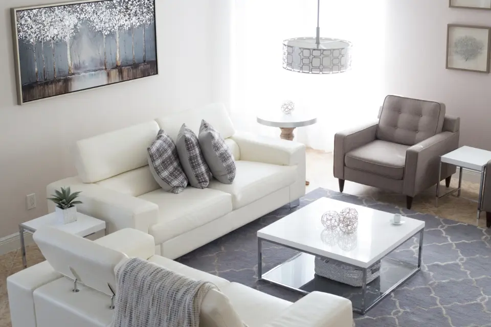 Representative photo, not the actual home: Bright living room with white sofas and a coffee table